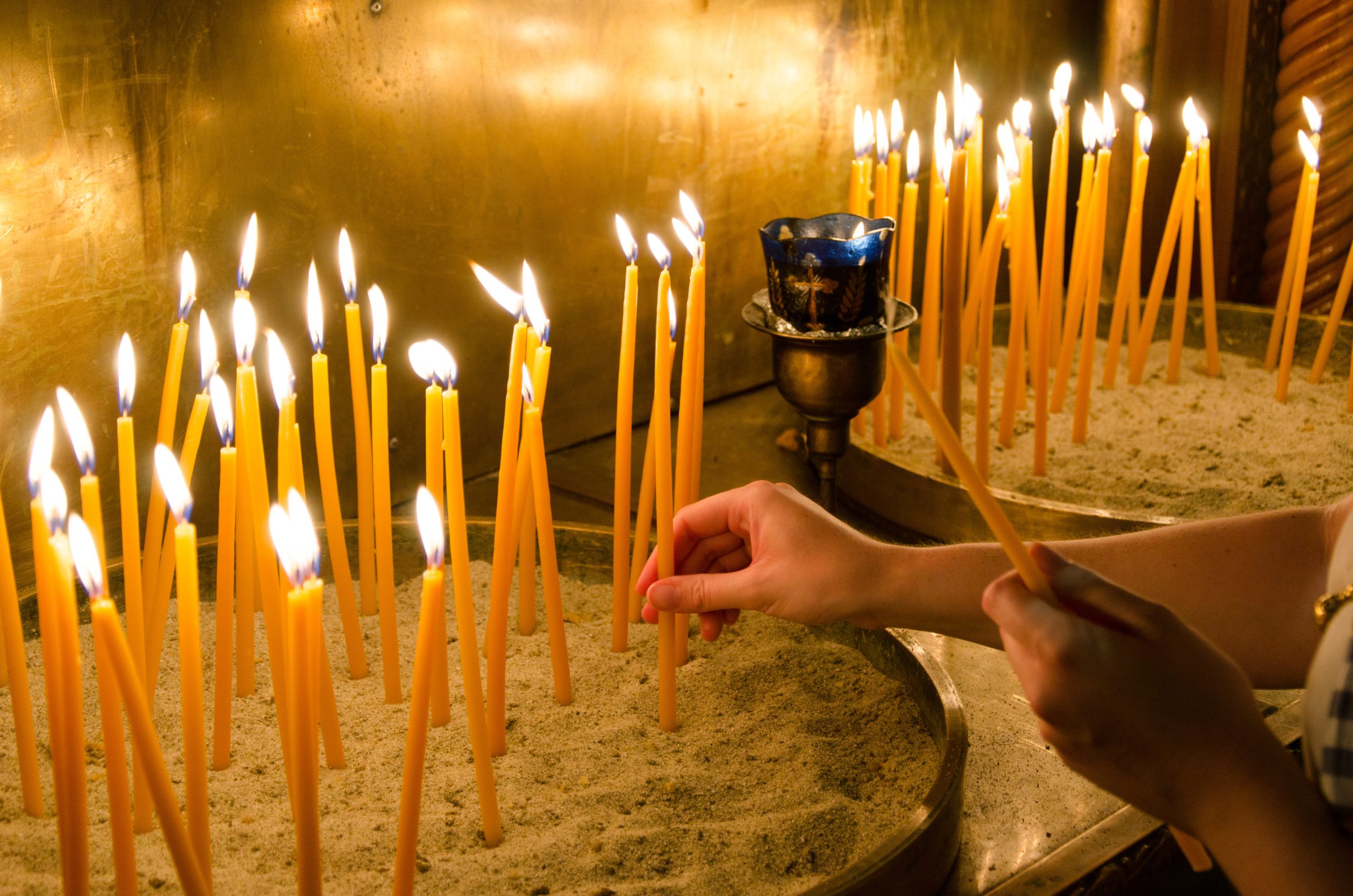 Igniting candles in a greek orthodox church
